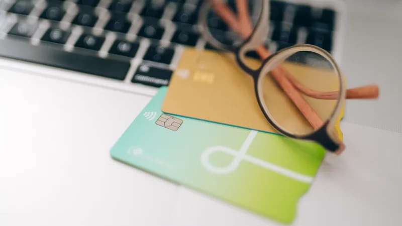 Two credit cards with magnifying glasses comparing options