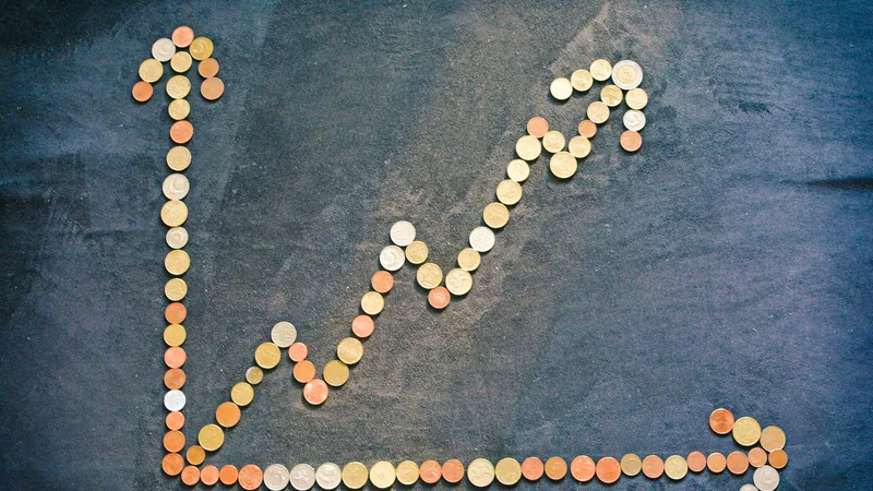 Rising financial chart made of coins representing credit score improvement