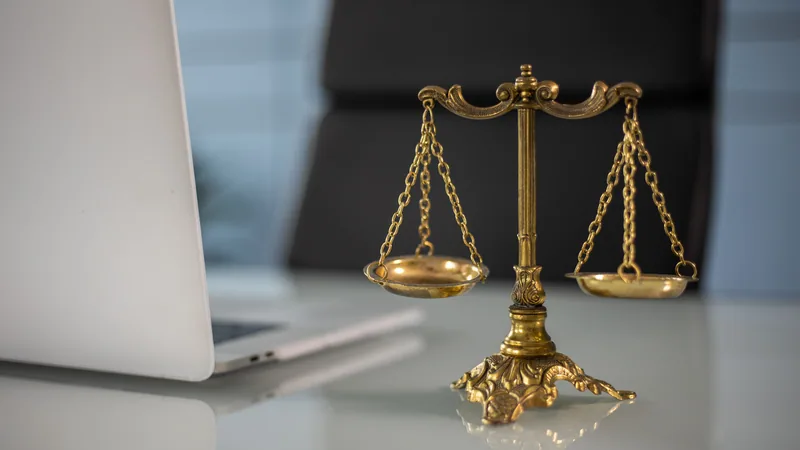 Golden scales of justice on desk comparing credit card options